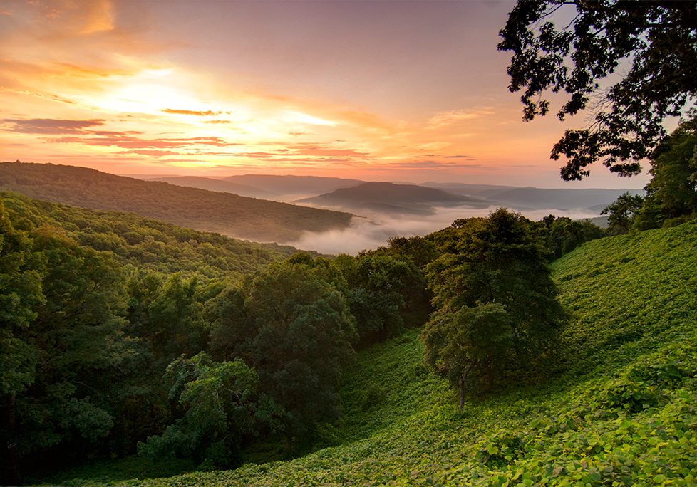 _0025_GettyImages-505535371 A view of the sun setting over a valley.