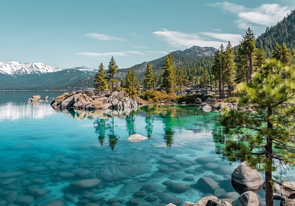 _0006_GettyImages-1160846801 A body of water with trees and mountains in the background.