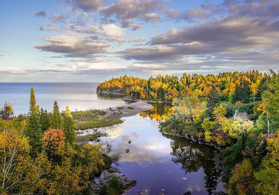 _0022_GettyImages-1301638912 A body of water with trees and clouds in the sky.