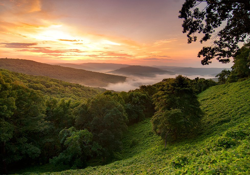 _0025_GettyImages-505535371 A view of the sun setting over a valley.